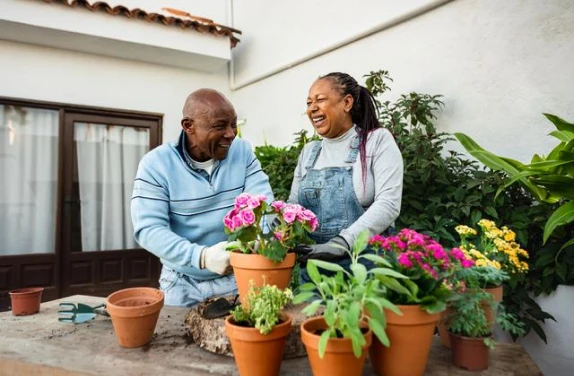 Couple gardening outside their home