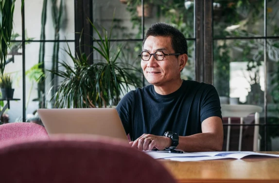 Man in glasses using laptop