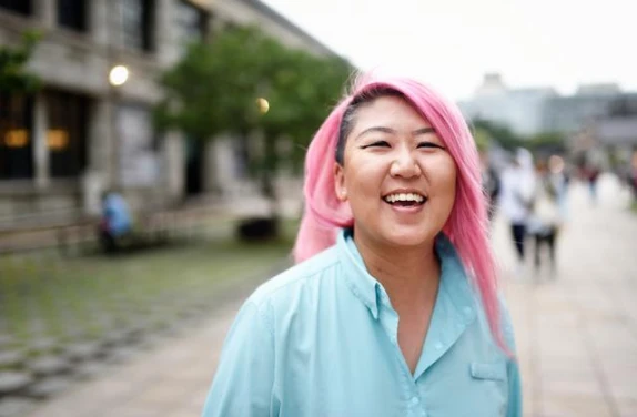 Smiling female with pink hair