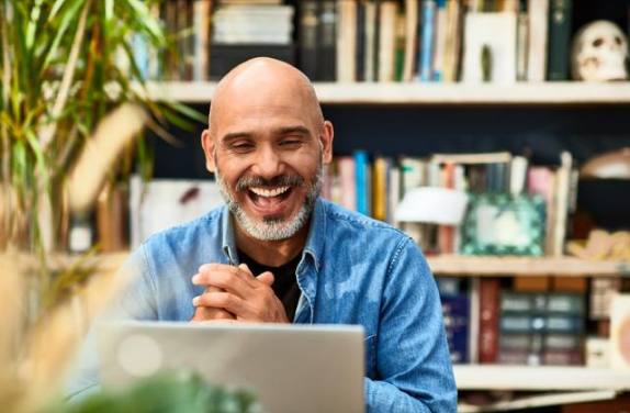 Man smiling at laptop
